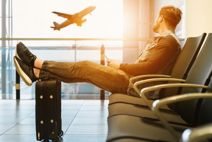 man sitting on chair looking at plane