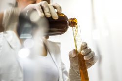scientist pouring liquid in to tube