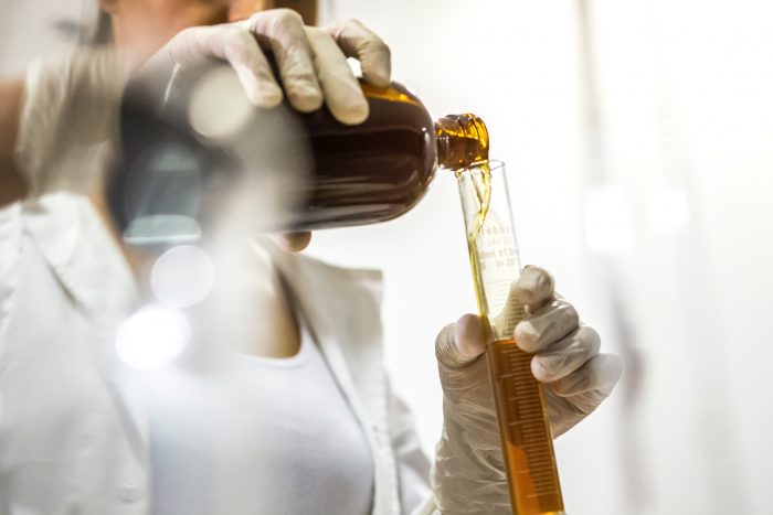 scientist pouring liquid in to tube